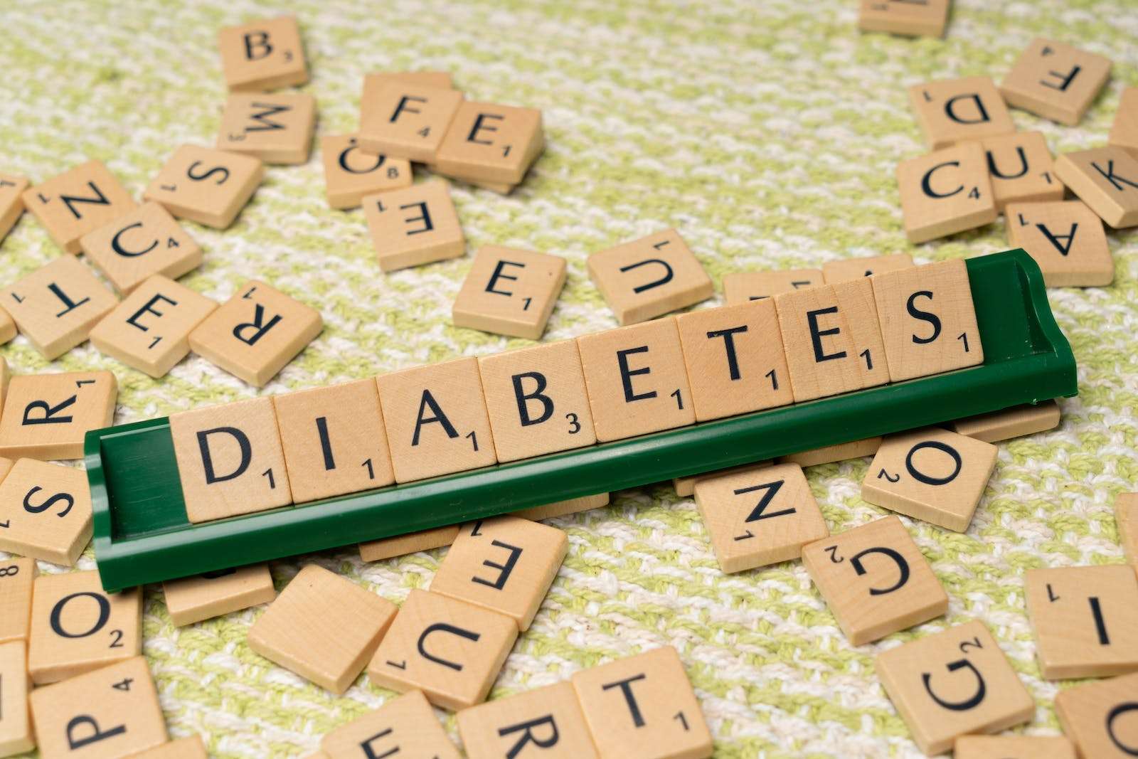 HbA1c test and Diabetes and the word diabetes on a green background
