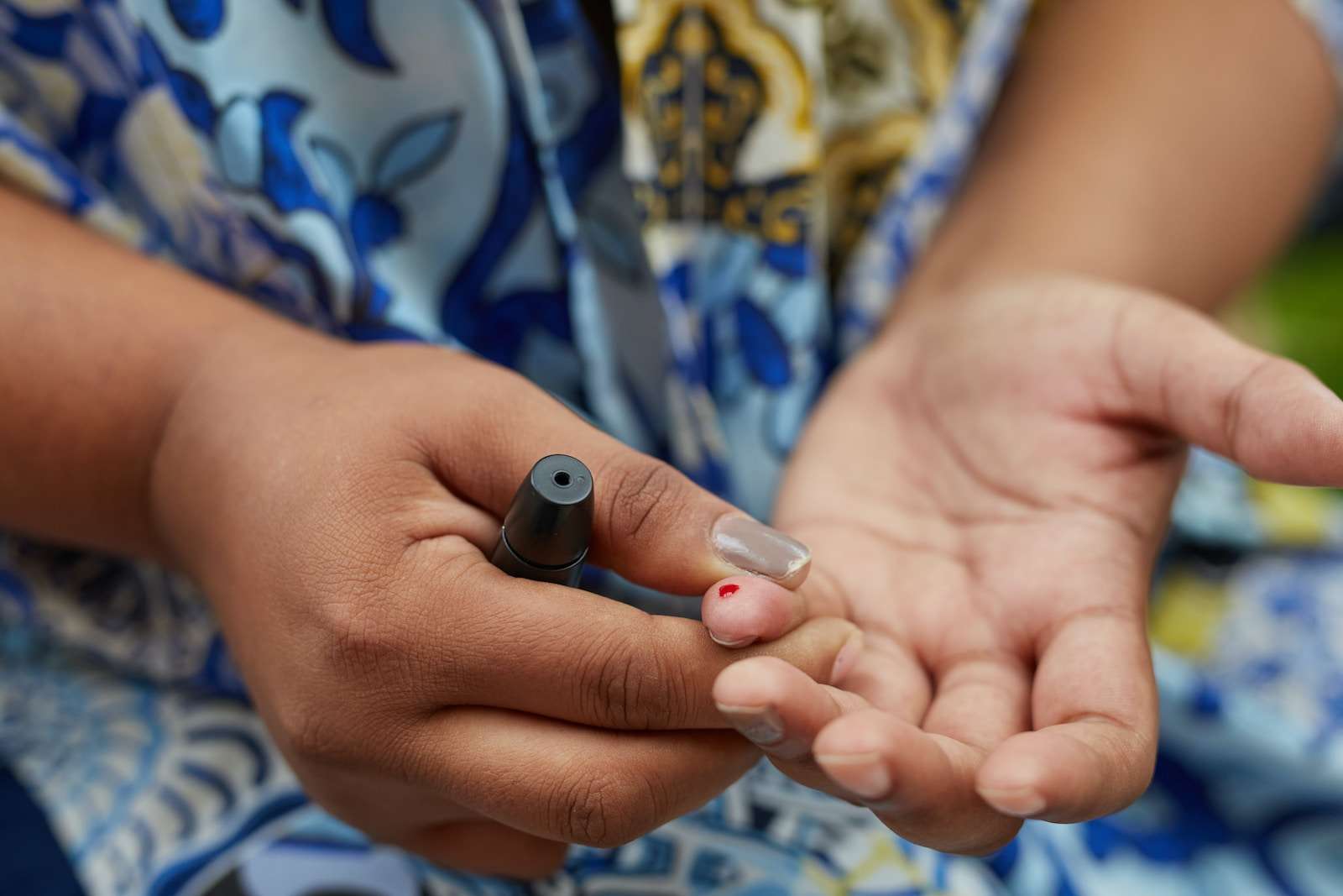 continuous glucose monitoring or CGM a close up of a person holding something in their hands