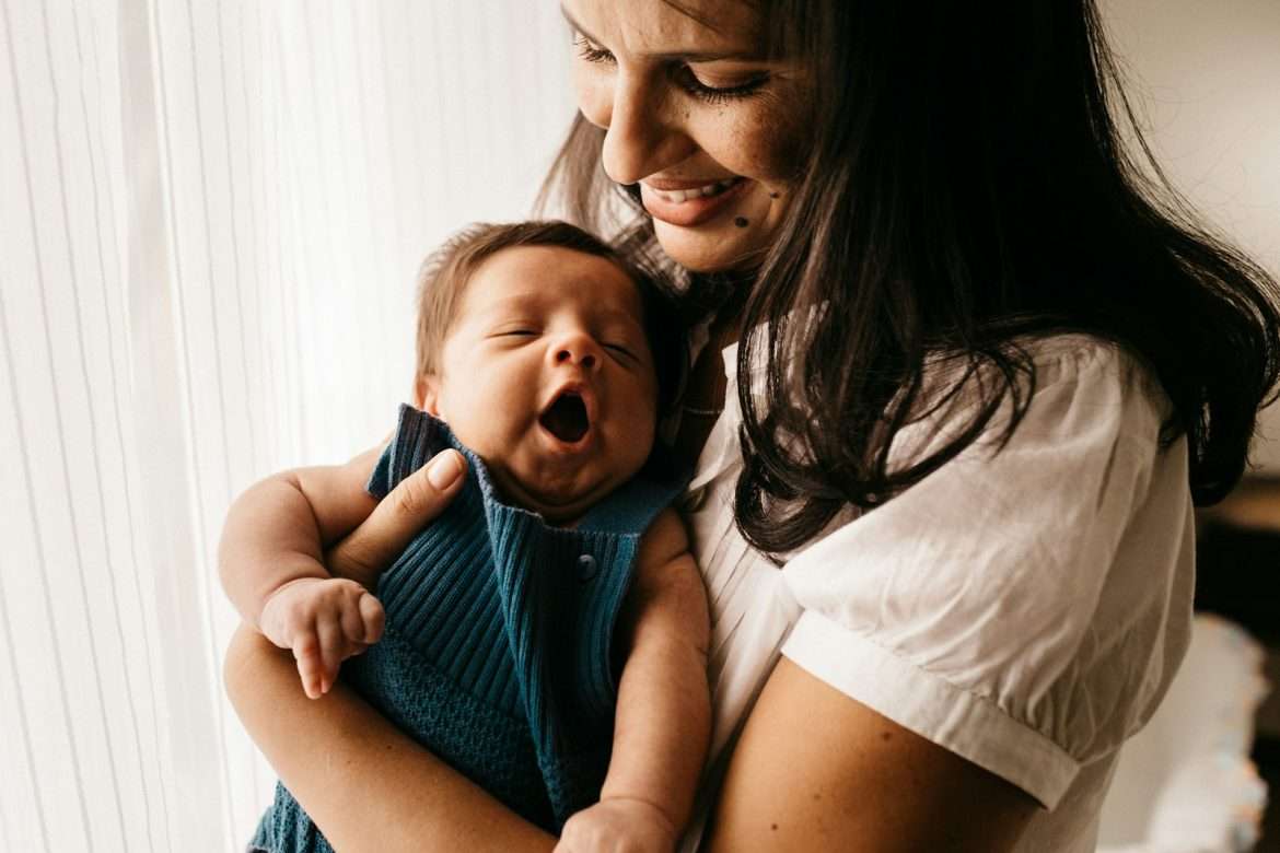 How to bounce back after Giving birth woman in white shirt carrying girl in blue shirt