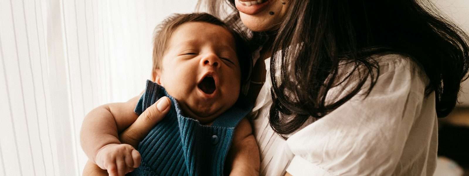 How to bounce back after Giving birth woman in white shirt carrying girl in blue shirt