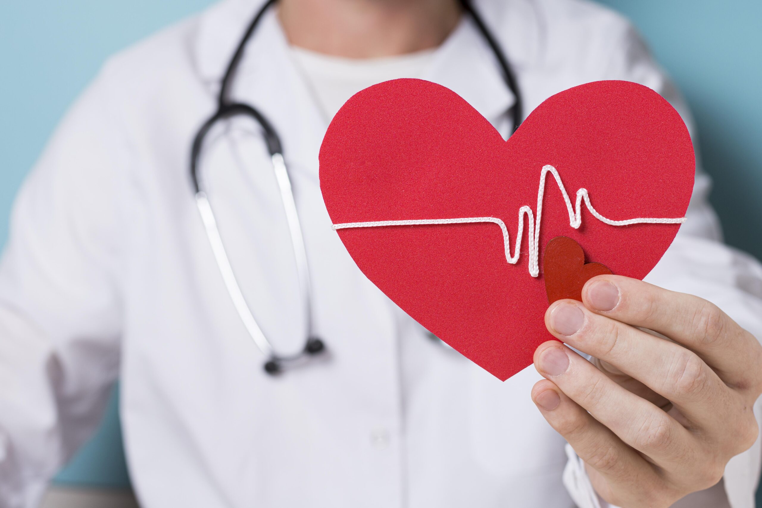 Heart attack recovery - doctor holding heart shape