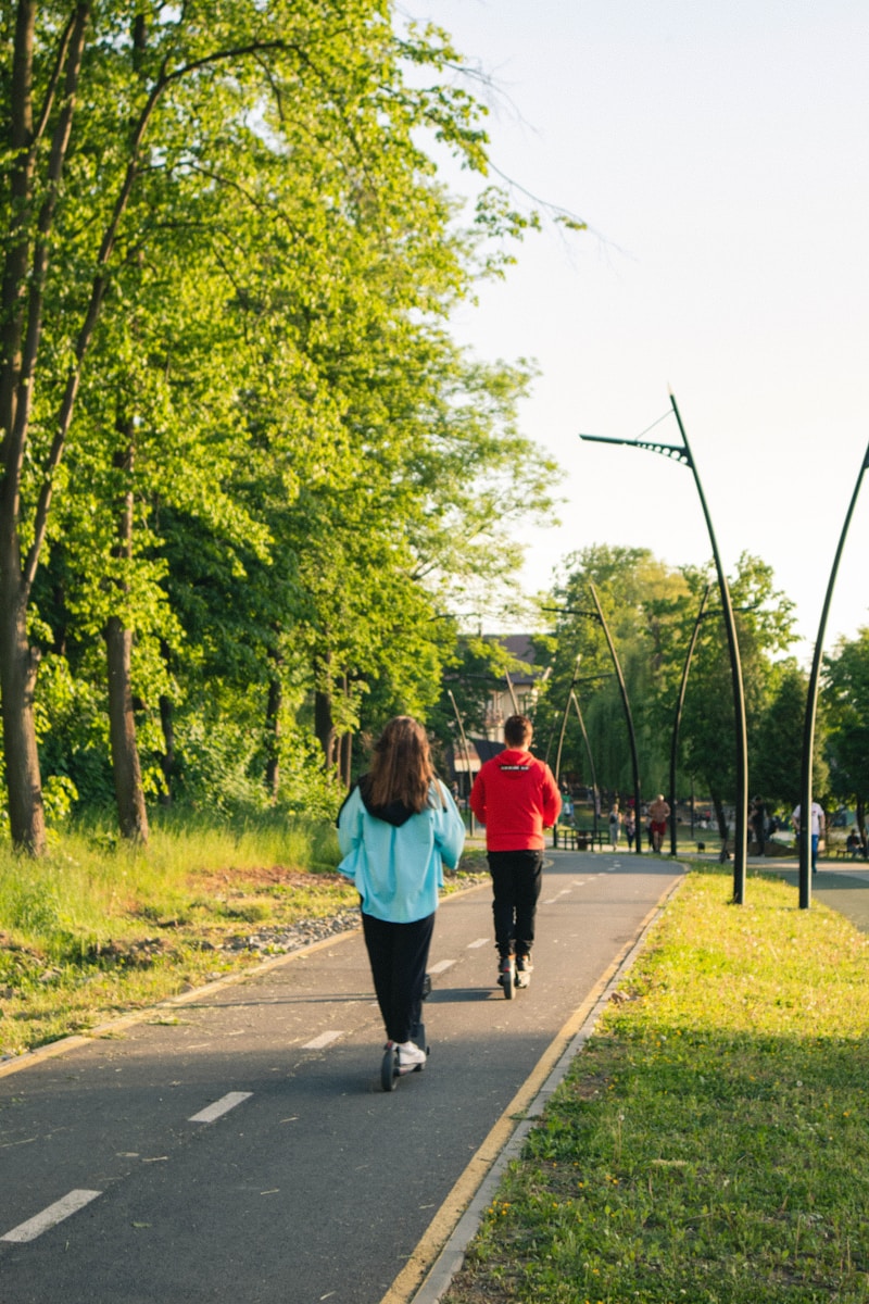 Quit smoking - Exercise a man and a woman jogging on a road with trees on either side