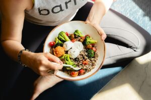 hunger and weight loss are connected a woman is holding a bowl of food
